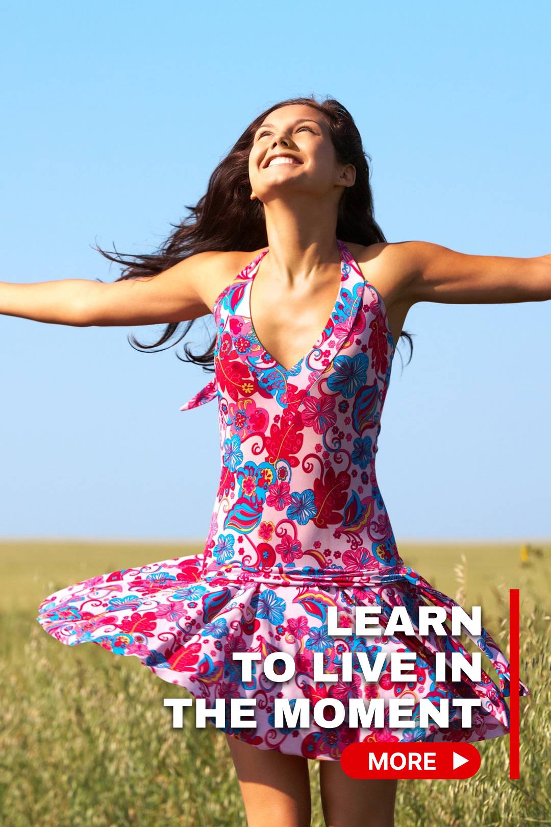 Beautiful smiling woman in a bright blue and red dress looking up in the sky and dancing in the field of wild flowers